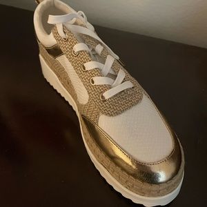 White and gold platform lace up shoe.